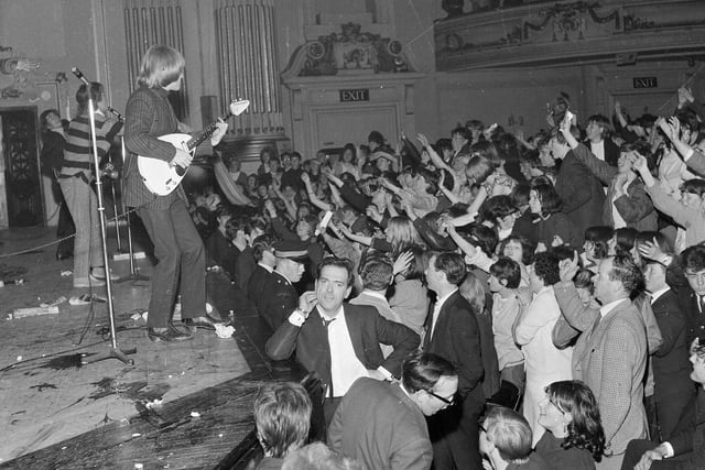 The Rolling Stones at the Usher Hall, Edinburgh in June 1965 with crowds of screaming fans at the stage.