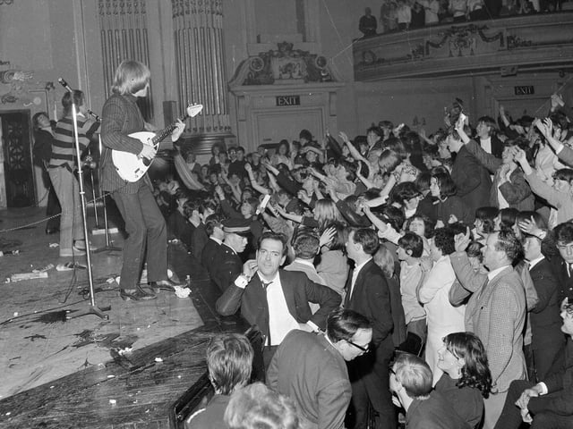The Rolling Stones at the Usher Hall, Edinburgh in June 1965 with crowds of screaming fans at the stage.