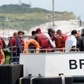 A group of people thought to be migrants are brought in to Dover