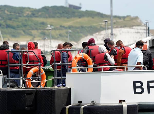 A group of people thought to be migrants are brought in to Dover