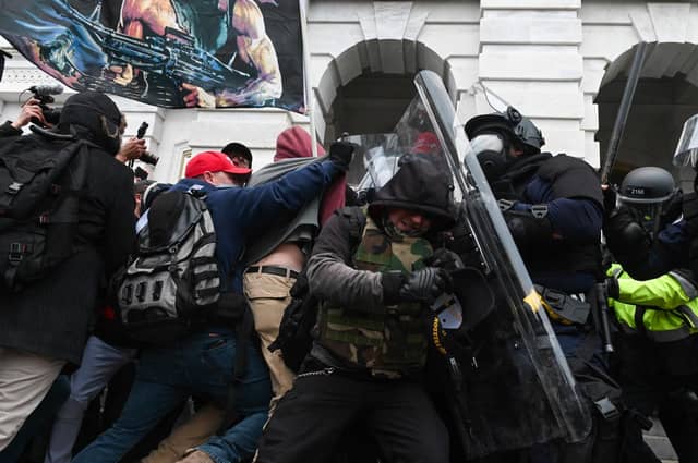 Riot police push back a crowd of Trump supporters after they stormed the US Capitol in Washington, DC (Picture: Roberto Schmidt/AFP via Getty Images)
