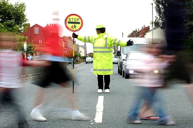 School crossing patrols are one of countless services in the firing line of councils tasked with balancing budgets. Picture: JPIMedia