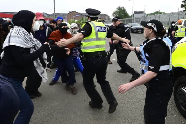 Police and pro-Palestinian protesters clash during a demonstration outside the entrance to a military electronics factory in Glasgow. Picture: John Devlin