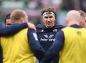 Jamie Ritchie of Scotland looks on as players of Scotland huddle against Ireland.