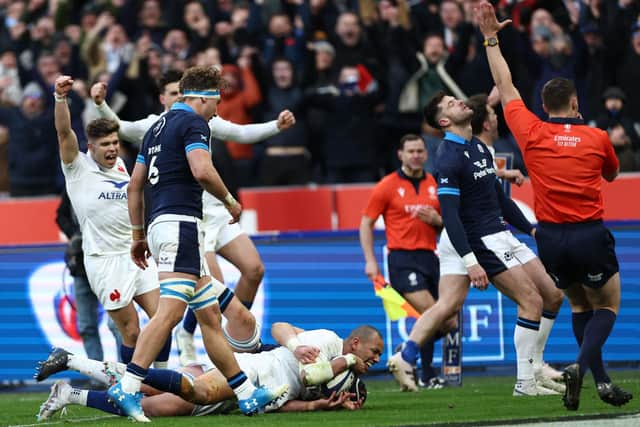 France centre Gael Fickou (bottom) scores the final try to seal the 32-21 victory over Scotland. (Photo by ANNE-CHRISTINE POUJOULAT/AFP via Getty Images)