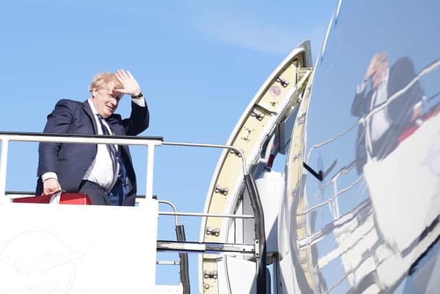 Boris Johnson boards a plane at Stansted Airport for a visit to India
