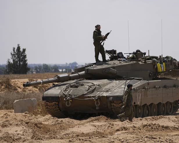 Israeli soldiers are seen near the border with the Gaza Strip, in southern Israel, on Tuesday. Photo: AP Photo/Tsafrir Abayo