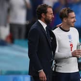 England manager Gareth Southgate (L) speaks with England's midfielder Jack Grealish (R) before the player was substituted on during the Euro 2020 semi-final win over Denmark. Grealish was later taken off again. (Photo by Laurence Griffiths / POOL / AFP) (Photo by LAURENCE GRIFFITHS/POOL/AFP via Getty Images)