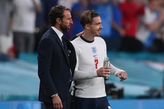 England manager Gareth Southgate (L) speaks with England's midfielder Jack Grealish (R) before the player was substituted on during the Euro 2020 semi-final win over Denmark. Grealish was later taken off again. (Photo by Laurence Griffiths / POOL / AFP) (Photo by LAURENCE GRIFFITHS/POOL/AFP via Getty Images)