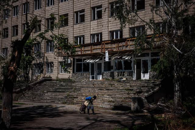 A local resident walks past a damaged building in the town of Irpin, near Kyiv. Picture: Dimitar Dilkoff/AFP via Getty Images