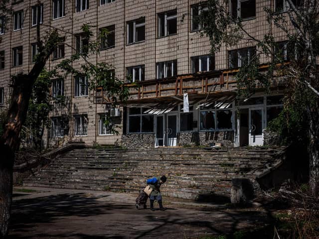 A local resident walks past a damaged building in the town of Irpin, near Kyiv. Picture: Dimitar Dilkoff/AFP via Getty Images