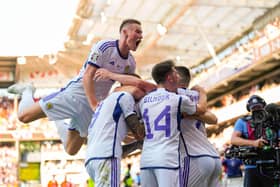 Scotland's players celebrate after Lyndon Dykes equaliser in Norway. (Photo by FREDRIK VARFJELL/NTB/AFP via Getty Images)