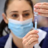 Medical staff and volunteers prepare shots of the Moderna vaccine at an NHS Covid-19 vaccination centre on December 16, 2021. Photo: Leon Neal - WPA Pool/Getty Images.