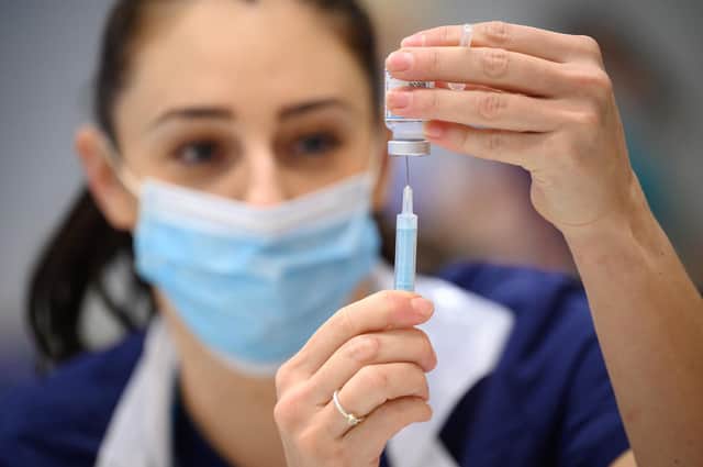Medical staff and volunteers prepare shots of the Moderna vaccine at an NHS Covid-19 vaccination centre on December 16, 2021. Photo: Leon Neal - WPA Pool/Getty Images.