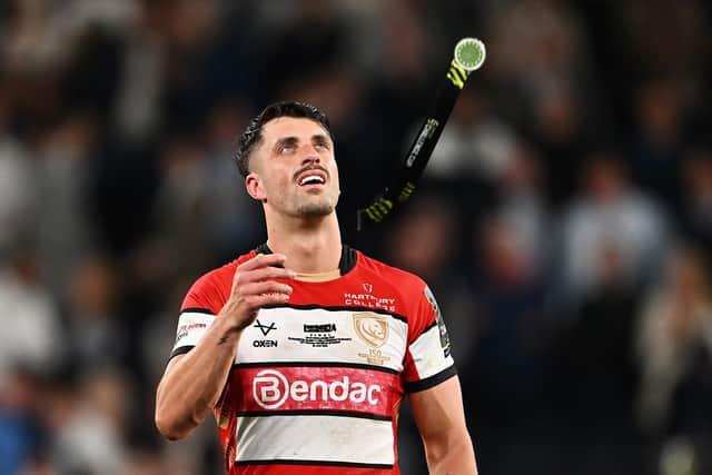 Adam Hastings of Gloucester throws up his runners-up medal after the EPCR Challenge Cup final defeat by Sharks at Tottenham Hotspur Stadium. (Photo by Dan Mullan/Getty Images)