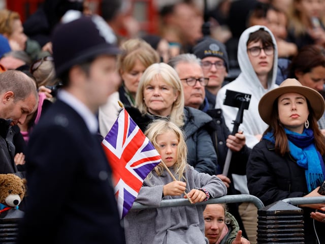 Members of the public gather before the Ceremonial Procession for the State Funeral of Queen Elizabeth II, held at Westminster Abbey, London. Picture date: Monday September 19, 2022.