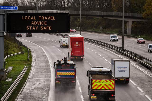 Motorists pass a motorway gantry sign on the M8 earlier this week