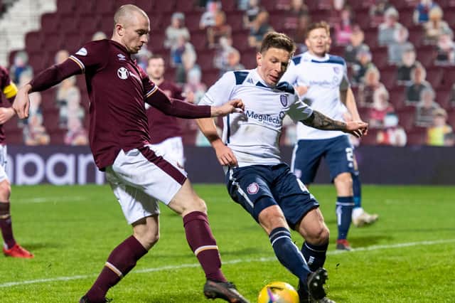 Former Hearts striker Craig Wighton (left) competes with Arbroath's Ricky Little in his penultimate appearance for the club in December (Photo by Paul Devlin / SNS Group)