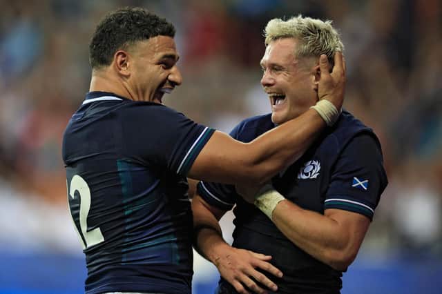 Scotland's wing Darcy Graham celebrates with Scotland's inside centre Sione Tuipulotu after beating Tonga.