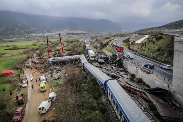 Police and emergency crews search the debris of a crushed wagon after a train accident in the Tempi Valley near Larissa, Greece. Picture: Zekas Leonidas/Eurokinissi/AFP via Getty Images
