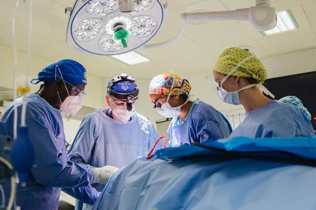 Scottish Surgeon, Manjit Dhillon (pictured in colourful surgical cap), performs the first complex three-hour surgery on board the world’s largest floating hospital, the Global Mercy in Sierra Leone.