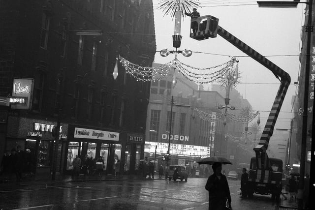 Glasgow Corporation workmen prepare the Christmas lights in Renfield Street, Glasgow, in 1966.