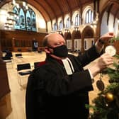 The Very Rev Dr Derek Browning puts the final touches on the Christmas tree inside Morningside Parish Church