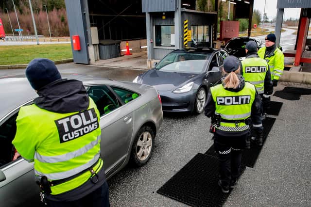 Customs officers and police check car drivers at the border between Norway and Sweden in Swinesund in March last year after the Covid outbreak began (Picture: Vidar Ruud/NTB Scanpix/AFP via Getty Images)
