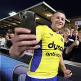 Finn Russell of Bath Rugby takes a selfie with fans following the Gallagher Premiership Rugby match against Newcastle Falcons.