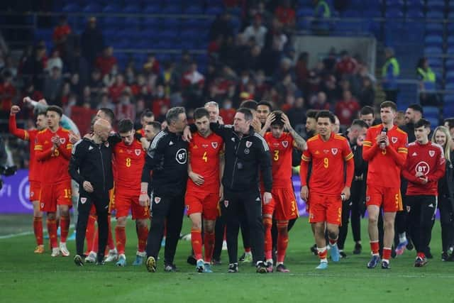 Wales' players celebrate on the pitch after the FIFA World Cup 2022 play-off semi-final qualifier football match between Wales and Austria at Cardiff City Stadium in Cardiff, south Wales on March 24, 2022. - A brilliant double from Gareth Bale took Wales to the brink of a first World Cup since 1958 thanks to a 2-1 win over Austria in Cardiff on Thursday. (Photo by GEOFF CADDICK/AFP via Getty Images)