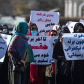 Women hold placards during a protest calling for their rights to be recognised, near the Shah-e-Do Shamshira mosque in Kabul .