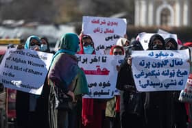 Women hold placards during a protest calling for their rights to be recognised, near the Shah-e-Do Shamshira mosque in Kabul .