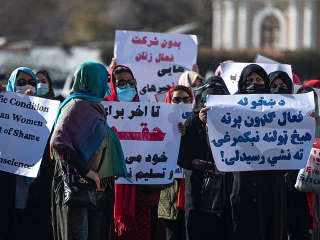 Women hold placards during a protest calling for their rights to be recognised, near the Shah-e-Do Shamshira mosque in Kabul .