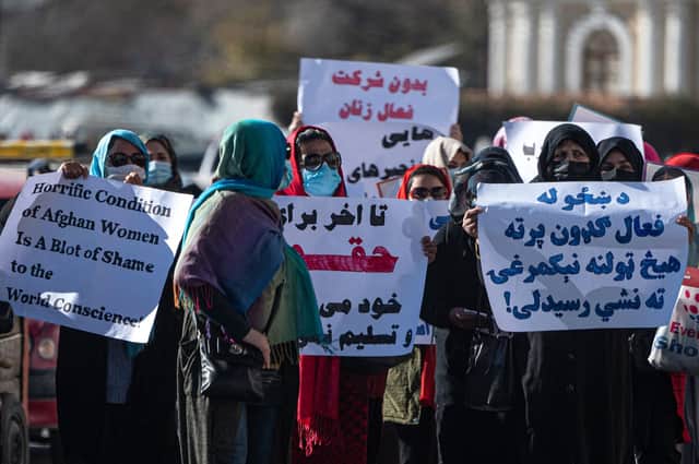Women hold placards during a protest calling for their rights to be recognised, near the Shah-e-Do Shamshira mosque in Kabul .