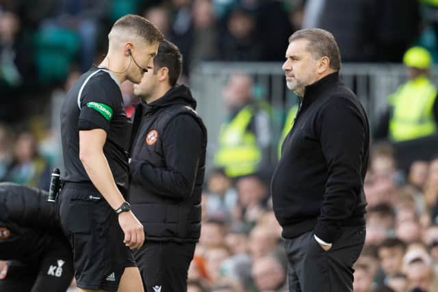 Referee David Dickinson walks past Celtic manager Ange Postecoglou as he checks the VAR screen during the match against Dundee United.  (Photo by Alan Harvey / SNS Group)