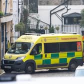 Staff shield the exit with umbrellas, alongside an ambulance, outside the rear of the King Edward VII Hospital in London where the Duke of Edinburgh was admitted on Tuesday. Picture: PA