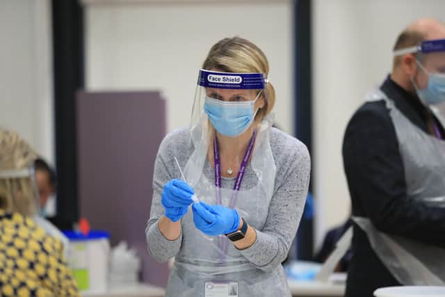 Lateral Flow Tests are processed as children arrive at Outwood Academy in Woodlands, Doncaster in Yorkshire. Picture date: Monday March 8, 2021.