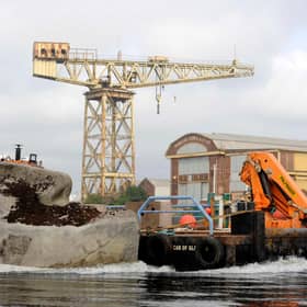 The Floating Head gets moved its new home at Canting Basin, near the Glasgow Science Centre, where family of the late artist Richard Groom cut the ribbon to officially mark its return to the water. PIC: Colin Hattersley.