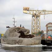 The Floating Head gets moved its new home at Canting Basin, near the Glasgow Science Centre, where family of the late artist Richard Groom cut the ribbon to officially mark its return to the water. PIC: Colin Hattersley.