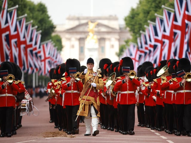 Soldiers take part in the parade along The Mall.