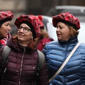 Tourists wearing tartan hats walk along the Royal Mile in Edinburgh. PA Photo. Picture: Andrew Milligan/PA Wire