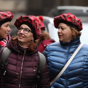Tourists wearing tartan hats walk along the Royal Mile in Edinburgh. PA Photo. Picture: Andrew Milligan/PA Wire