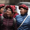 Tourists wearing tartan hats walk along the Royal Mile in Edinburgh. PA Photo. Picture: Andrew Milligan/PA Wire