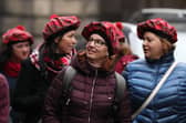 Tourists wearing tartan hats walk along the Royal Mile in Edinburgh. PA Photo. Picture: Andrew Milligan/PA Wire