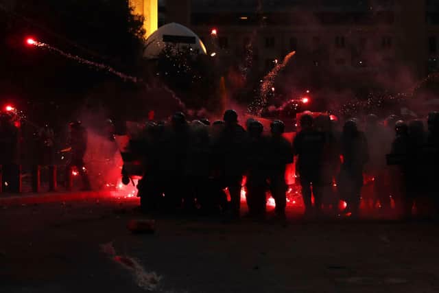 Anti-government protesters use fireworks against Lebanese riot police, during a protest in the aftermath of last Tuesday's massive explosion which devastated Beirut, Lebanon, Monday, Aug. 10, 2020. (AP Photo/Hassan Ammar)