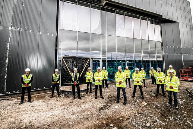 Members of the leadership team outside the new building at the recent topping out ceremony.