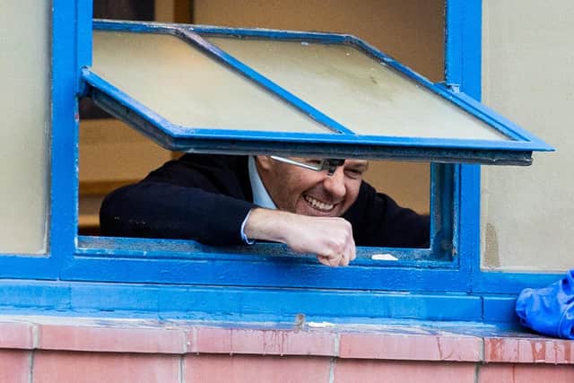 Rangers manager Steven Gerrard celebrates out the  window with fans outside after Rangers win over St Mirren put them on the brink ot the title - which has now been confirmed. (Photo by Craig Williamson / SNS Group)