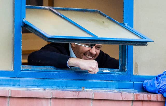 Rangers manager Steven Gerrard celebrates out the window with fans outside after Rangers win over St Mirren put them on the brink ot the title - which has now been confirmed. (Photo by Craig Williamson / SNS Group)