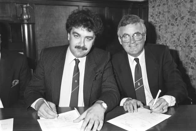 David Duff, left, pictured alongside Kenny Waugh as he signs the paperwork at Easter Road to buy Hibs back in 1987