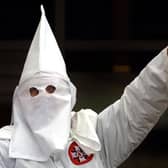 A Klansman raises his left arm during a "white power" chant at a Ku Klux Klan rally in 2000 (Getty Images)